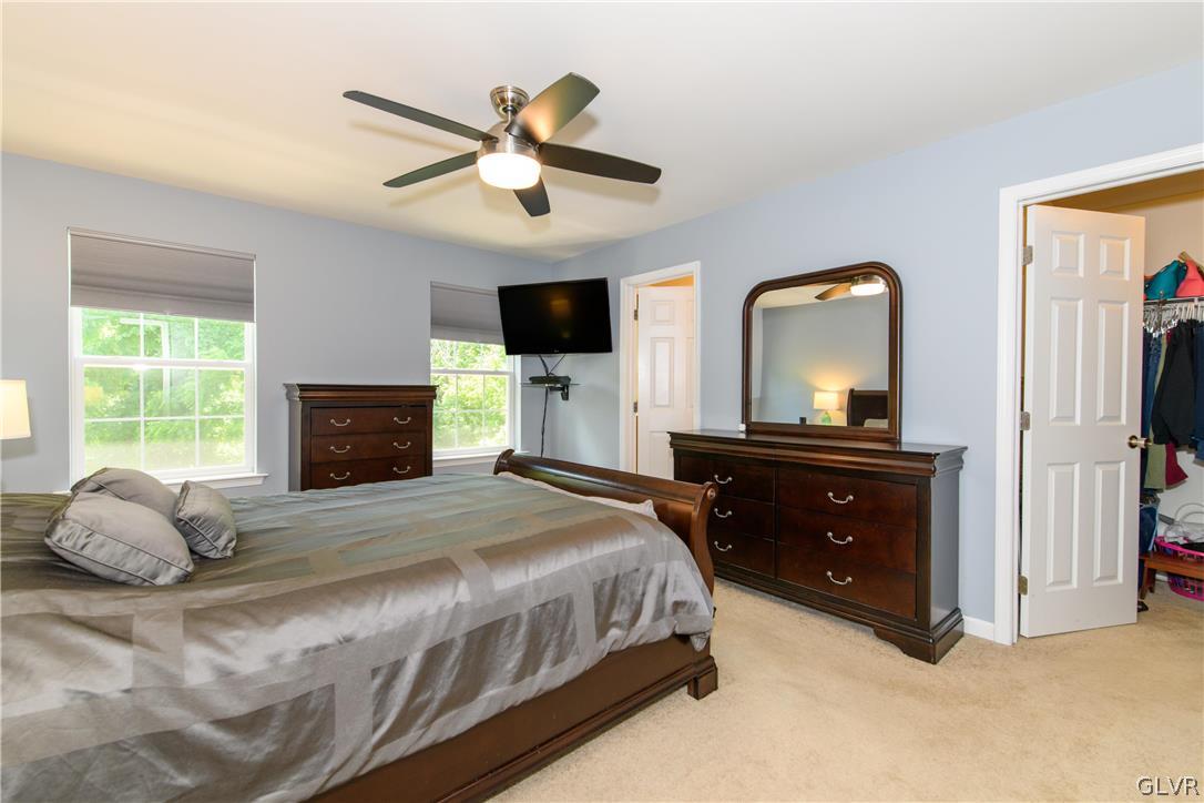 512 Racite Road Alburtis, PA 18011 - Photo 15 of 32 a bedroom with a bed and a flat tv screen on dresser