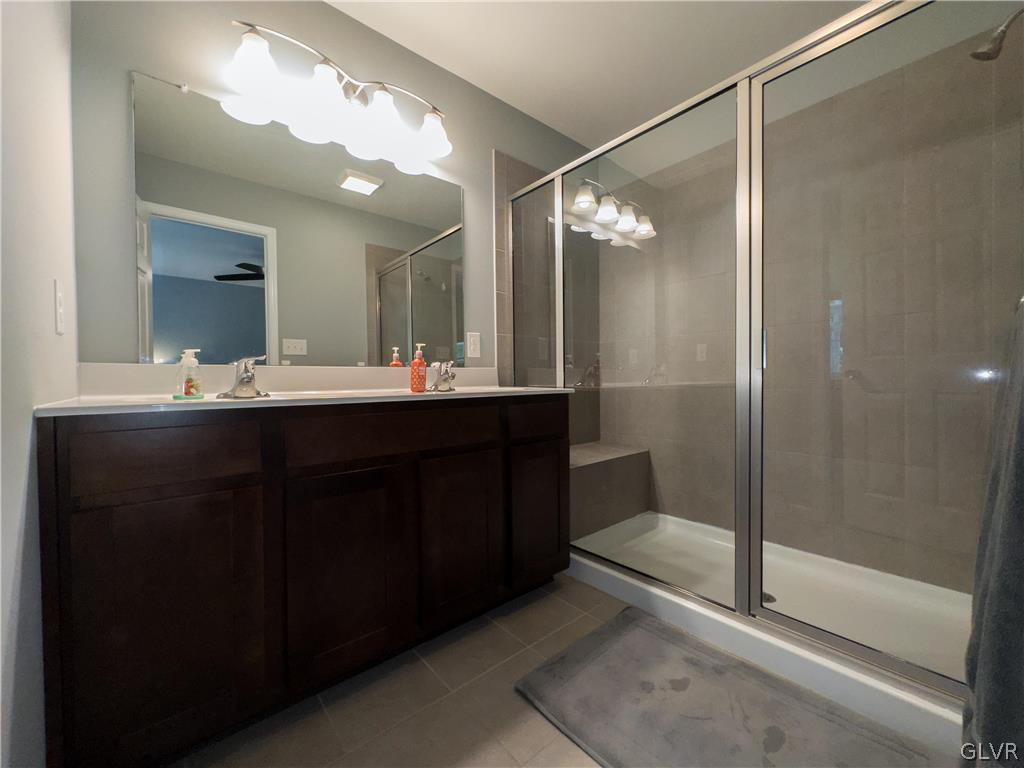 512 Racite Road Alburtis, PA 18011 - Photo 16 of 32 a bathroom with a double vanity sink mirror and shower