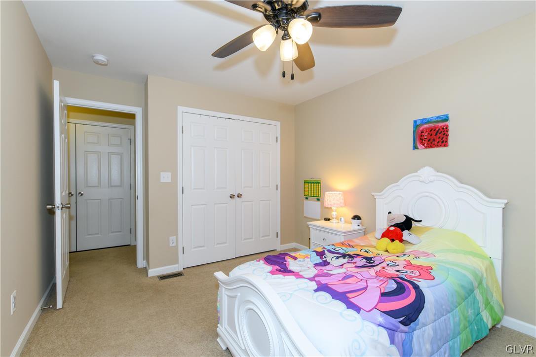 512 Racite Road Alburtis, PA 18011 - Photo 21 of 32 a bedroom with a bed and a chandelier