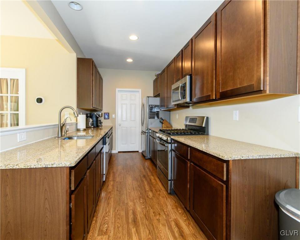 512 Racite Road Alburtis, PA 18011 - Photo 8 of 32 a kitchen with stainless steel appliances granite countertop sink stove refrigerator and cabinets
