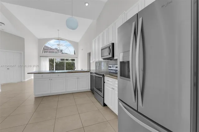 a kitchen with stainless steel appliances a refrigerator sink and microwave