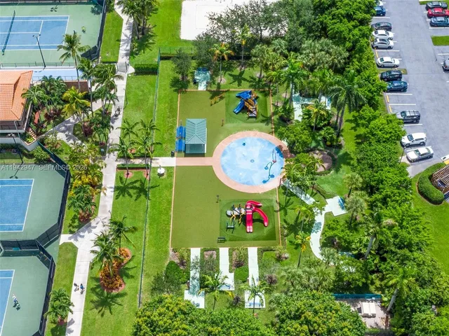 an aerial view of residential houses with outdoor space and street view