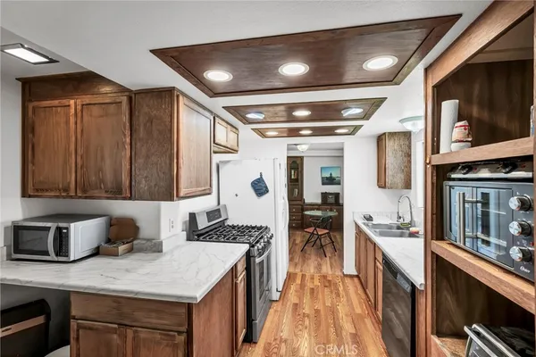 a kitchen with stainless steel appliances granite countertop a sink stove and cabinets