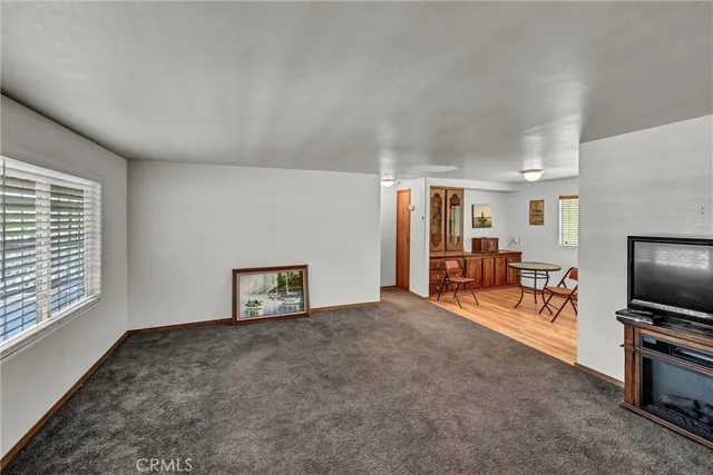 a view of a livingroom with furniture and a flat screen tv