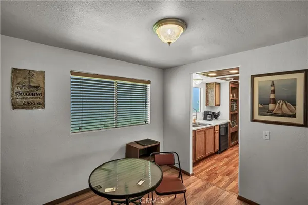 a view of a livingroom with furniture wooden floor and a window