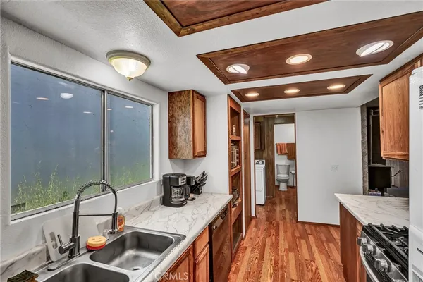a kitchen with a sink stove and a refrigerator
