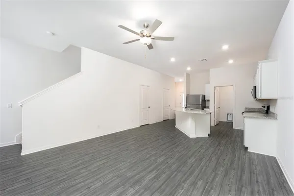 a view of kitchen with cabinets and wooden floor