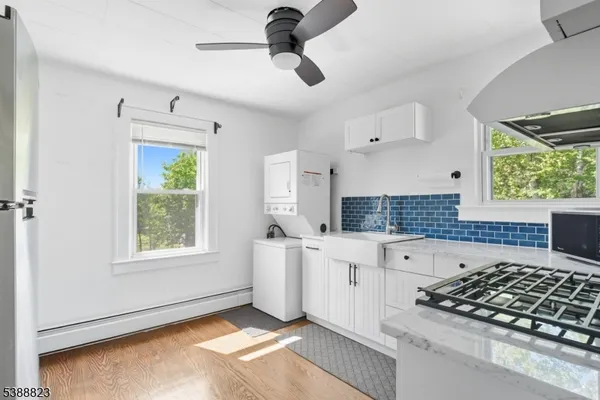 a kitchen with stainless steel appliances granite countertop a stove a sink and a window