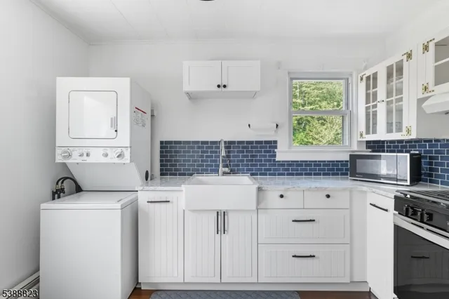 a kitchen with cabinets appliances and a window