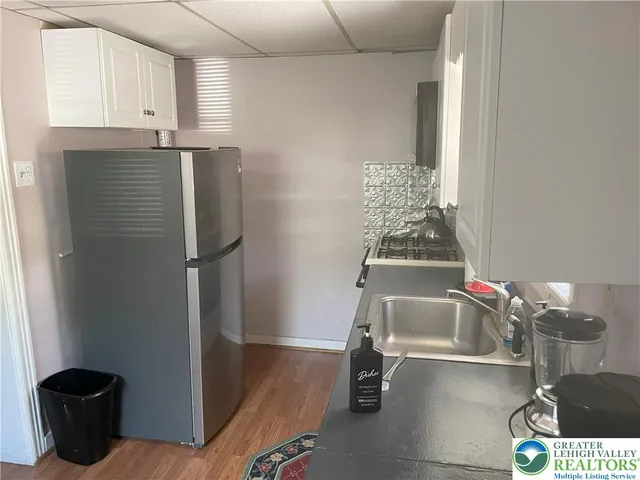a kitchen with a refrigerator and a stove