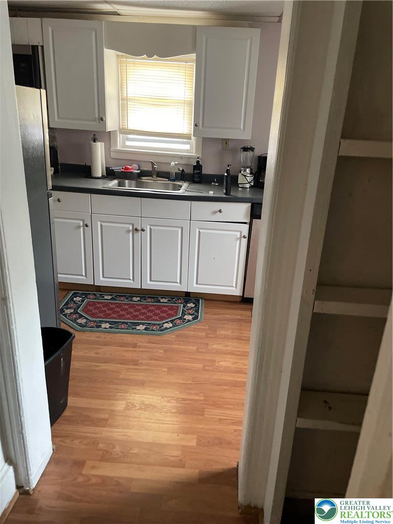 104 Washington Street Bath, PA 18014 - Photo 18 of 20 a kitchen with granite countertop a sink a stove a refrigerator and cabinets