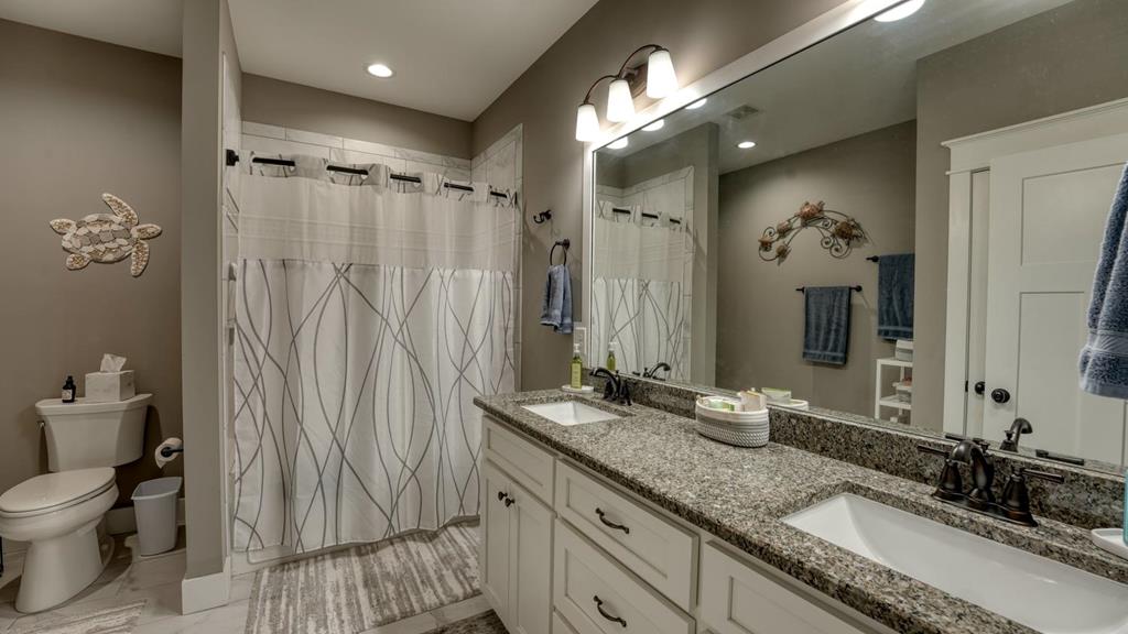 31 Elf School Road Hayesville, NC 28904 - Photo 46 of 59 a bathroom with a granite countertop sink toilet and shower