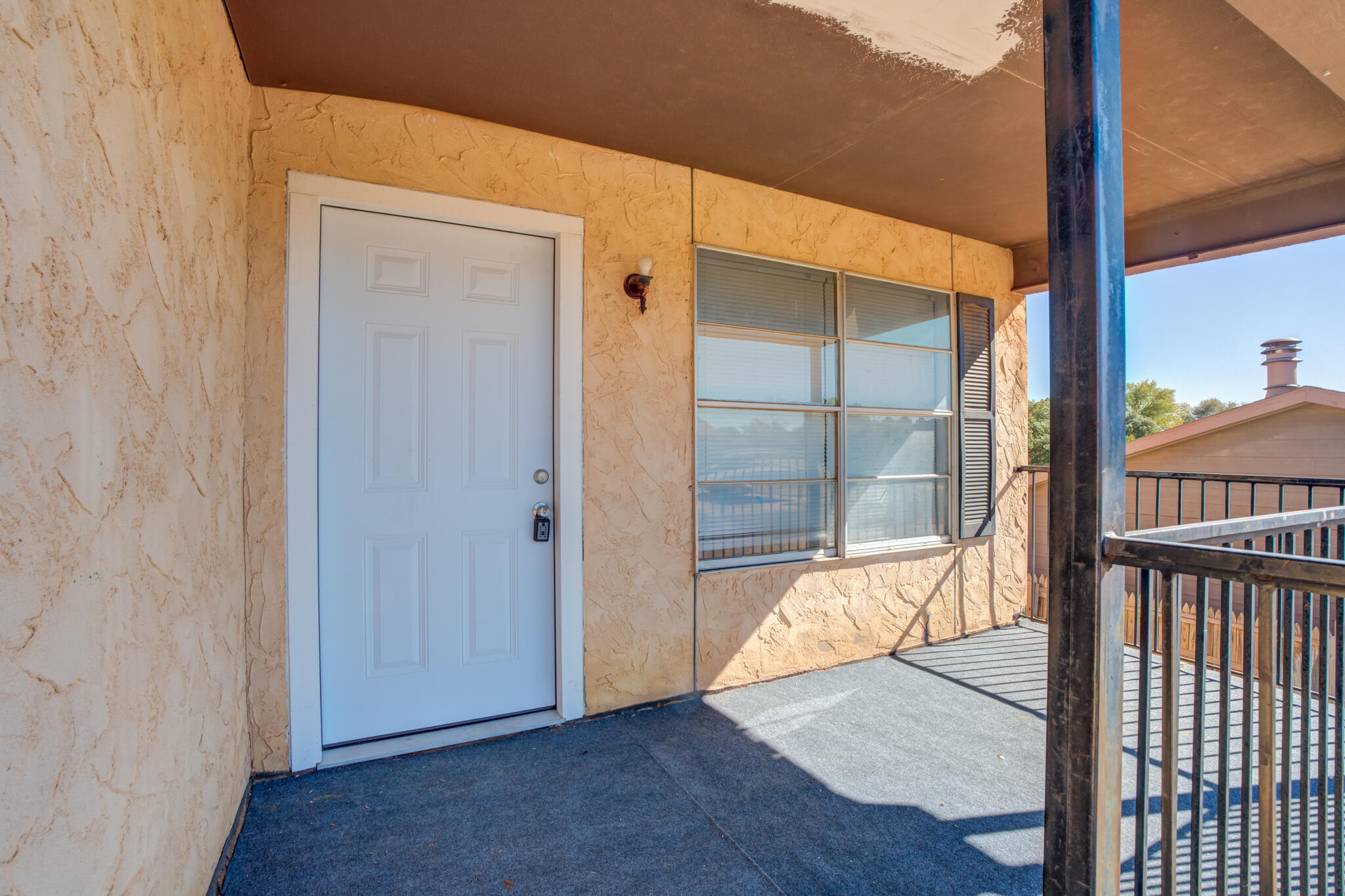 7405 Waco Avenue Lubbock, TX 79423 - Photo 7 of 29 an empty room with wooden floor and windows