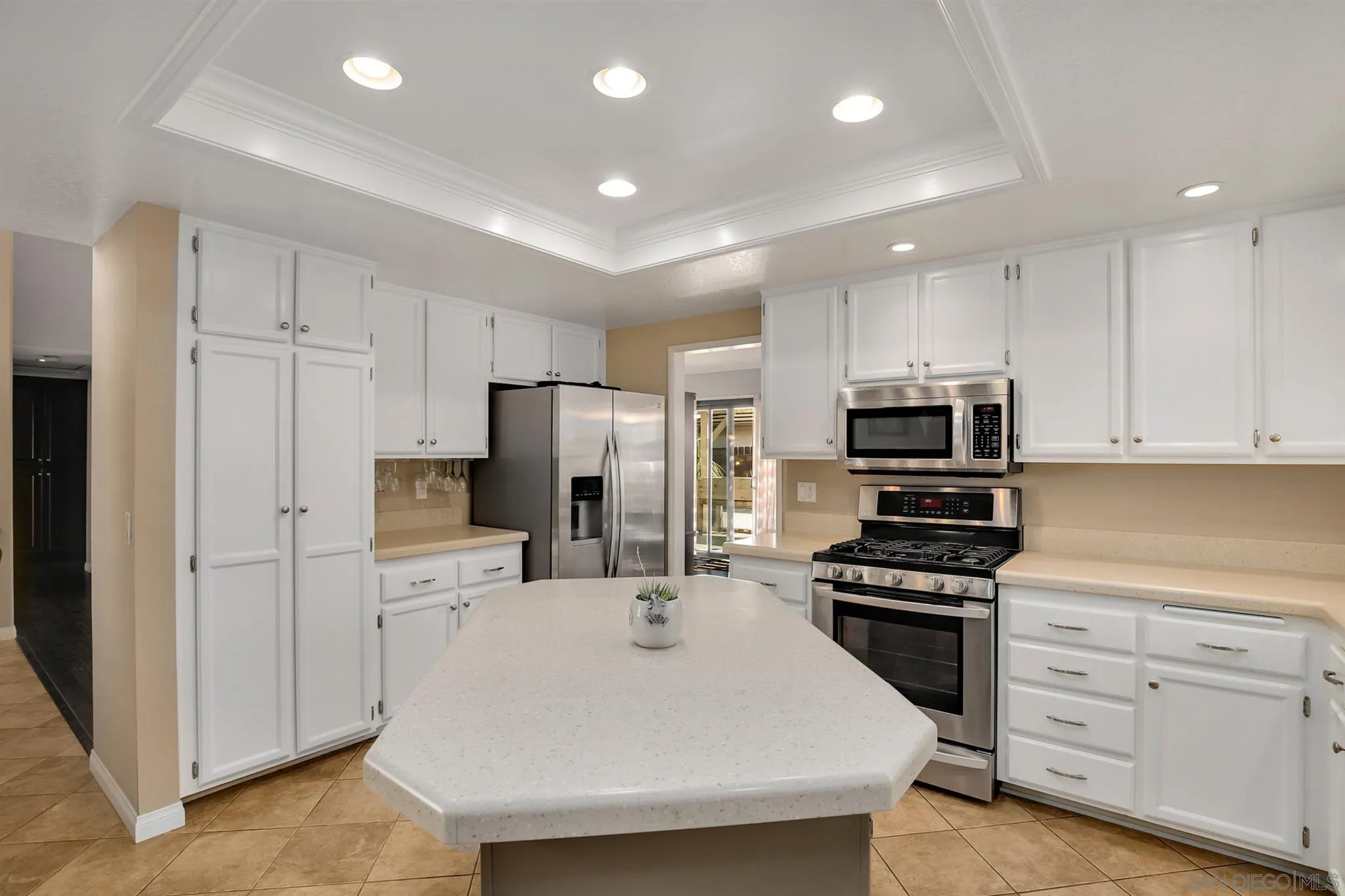 1753 Harold Road Escondido, CA 92026 - Photo 5 of 28 a kitchen with stainless steel appliances a refrigerator sink and white cabinets