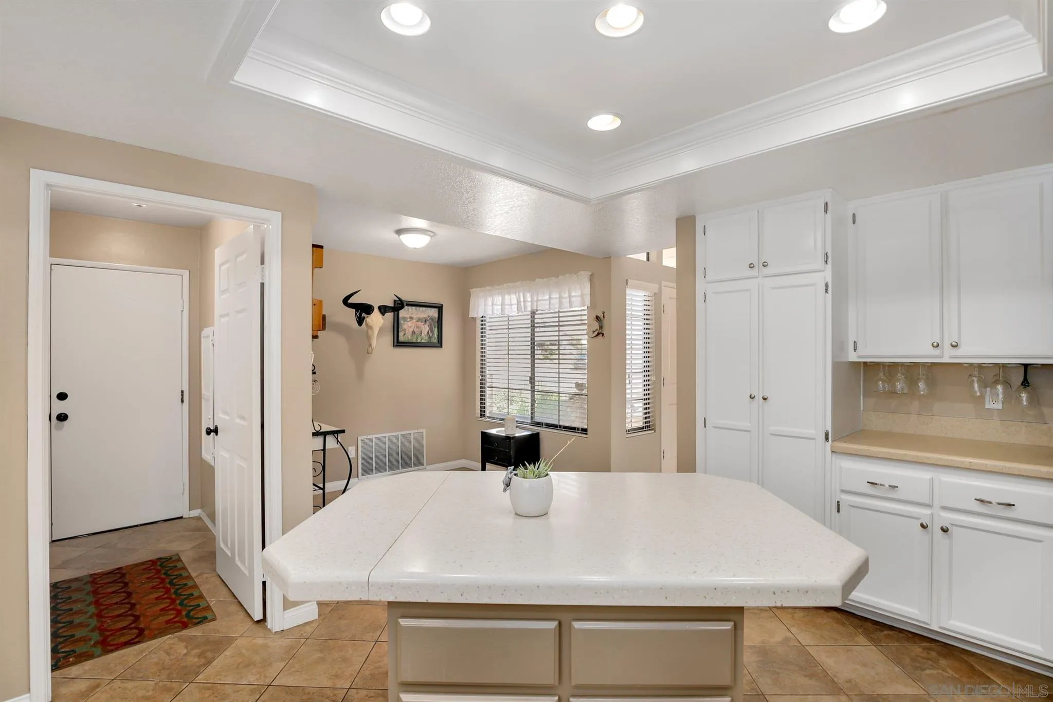 1753 Harold Road Escondido, CA 92026 - Photo 7 of 28 a large white kitchen with kitchen island a sink stainless steel appliances and cabinets