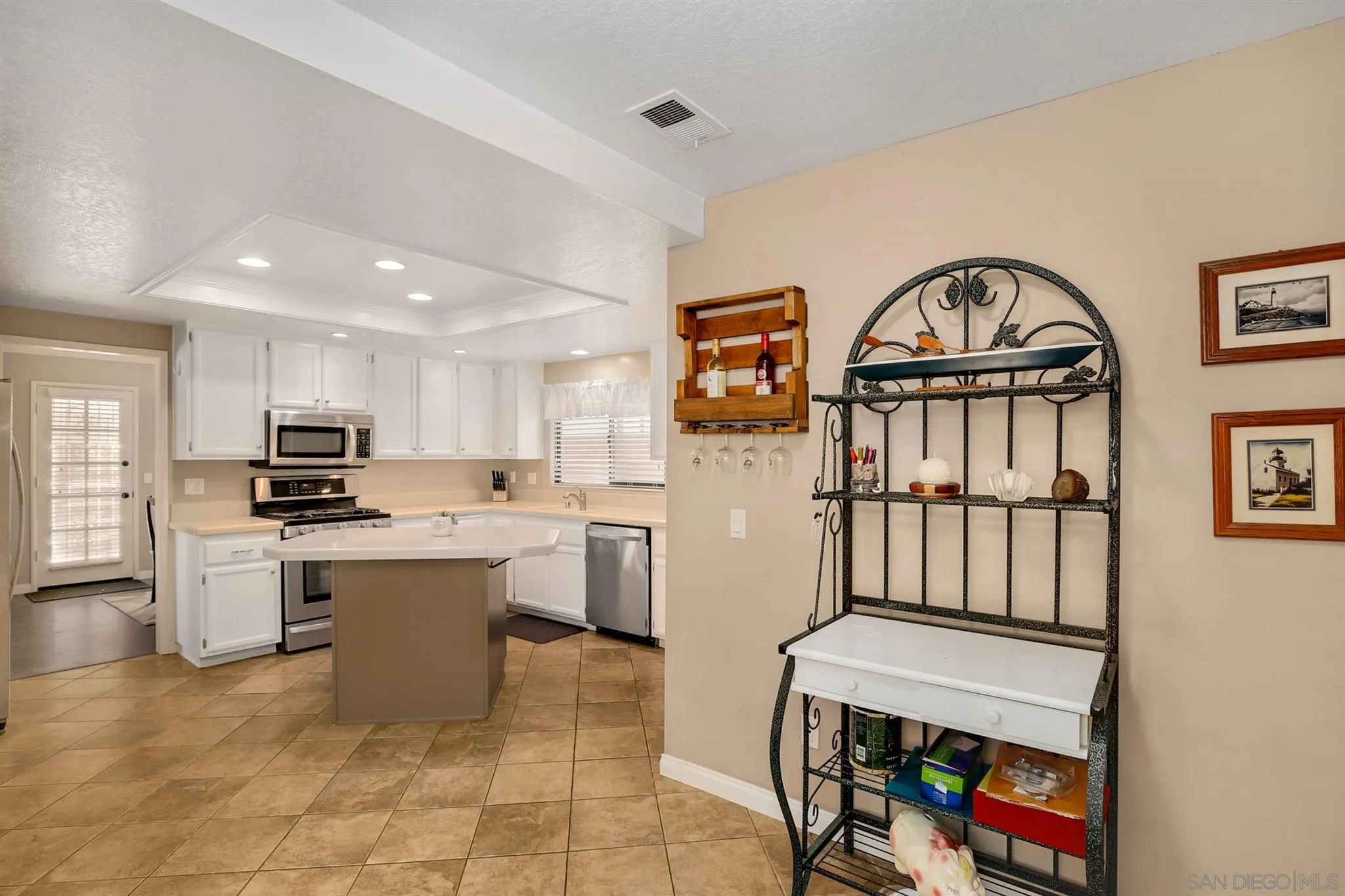1753 Harold Road Escondido, CA 92026 - Photo 9 of 28 a living room with furniture a flat screen tv and a kitchen