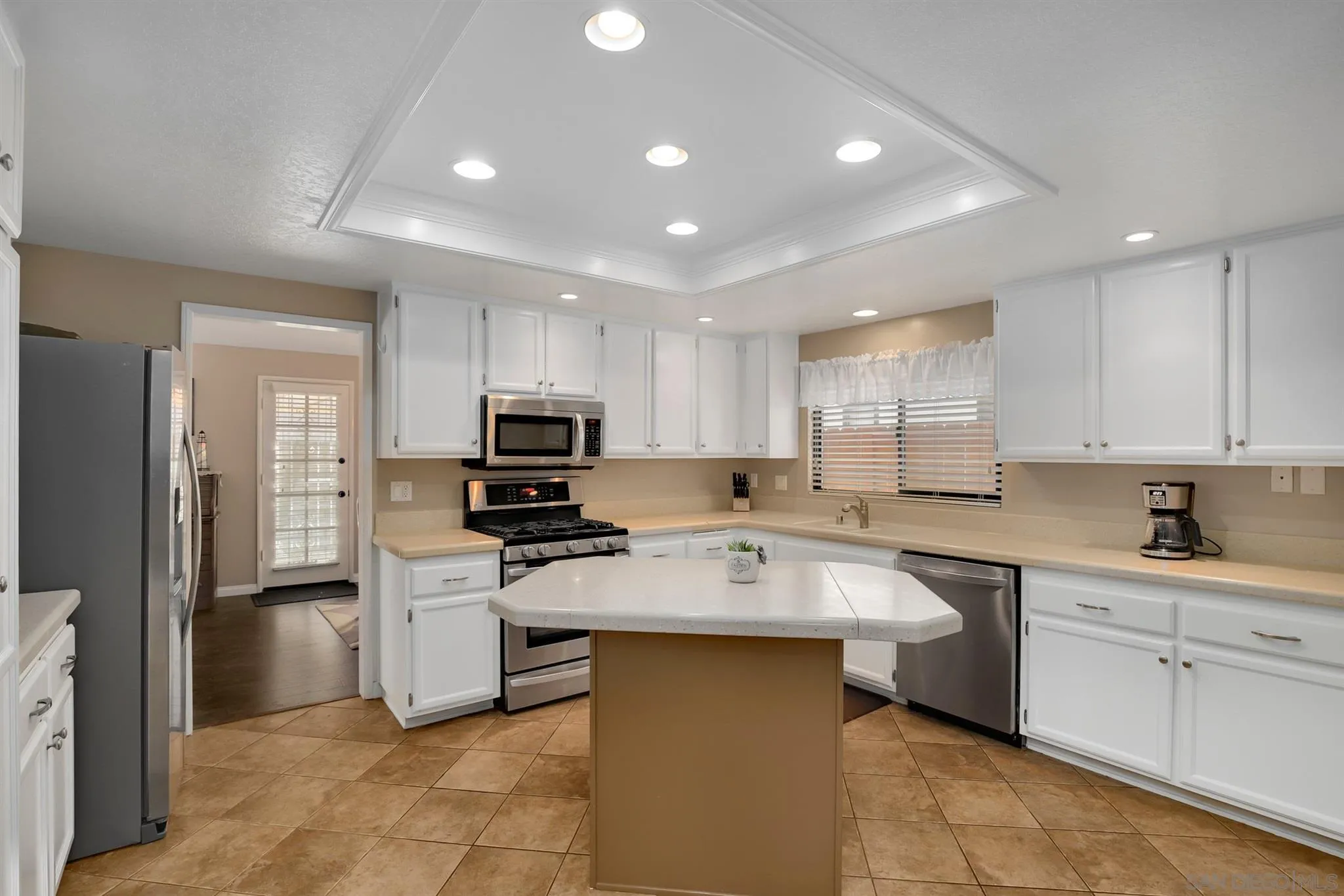 1753 Harold Road Escondido, CA 92026 - Photo 10 of 28 a kitchen with white cabinets sink and stainless steel appliances