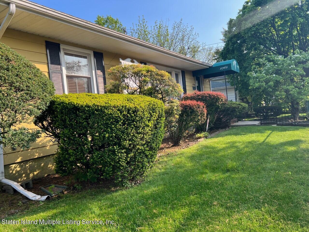 2760 Amboy Road Staten Island, NY 10306 - Photo 1 of 16 a front view of a house with garden