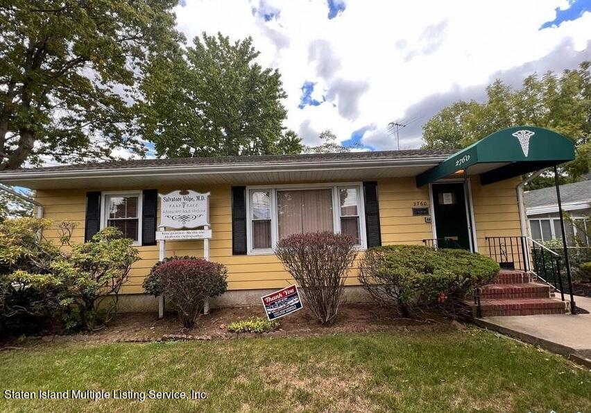 2760 Amboy Road Staten Island, NY 10306 - Photo 3 of 16 a front view of a house with garden