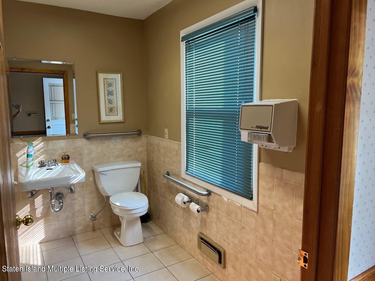 2760 Amboy Road Staten Island, NY 10306 - Photo 10 of 16 a bathroom with a toilet a sink and mirror