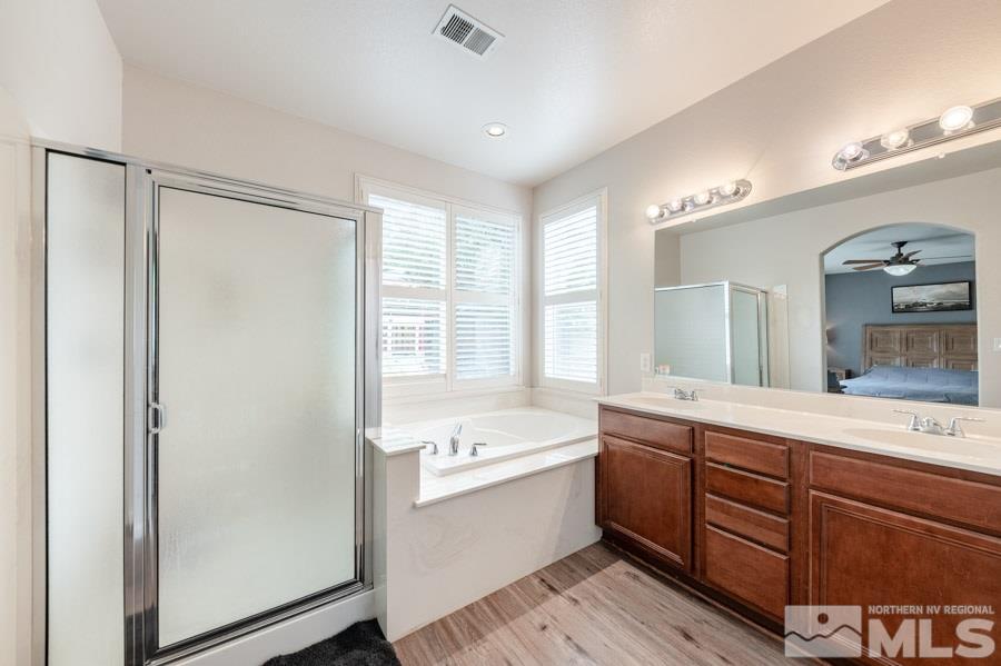 2104 Hazelcrest Drive Reno, NV 89521 - Photo 16 of 27 a bathroom with a tub a sink and mirror