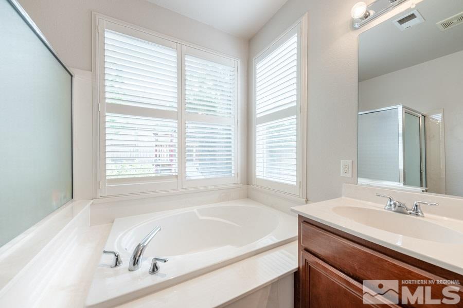2104 Hazelcrest Drive Reno, NV 89521 - Photo 17 of 27 a bathroom with a granite countertop sink and a bathtub