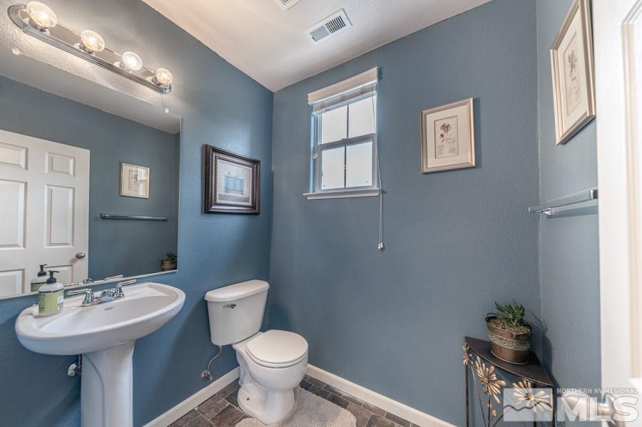 2104 Hazelcrest Drive Reno, NV 89521 - Photo 18 of 27 a bathroom with a toilet sink and mirror