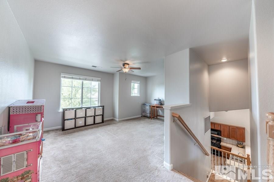 2104 Hazelcrest Drive Reno, NV 89521 - Photo 19 of 27 an empty room with windows and ceiling fan