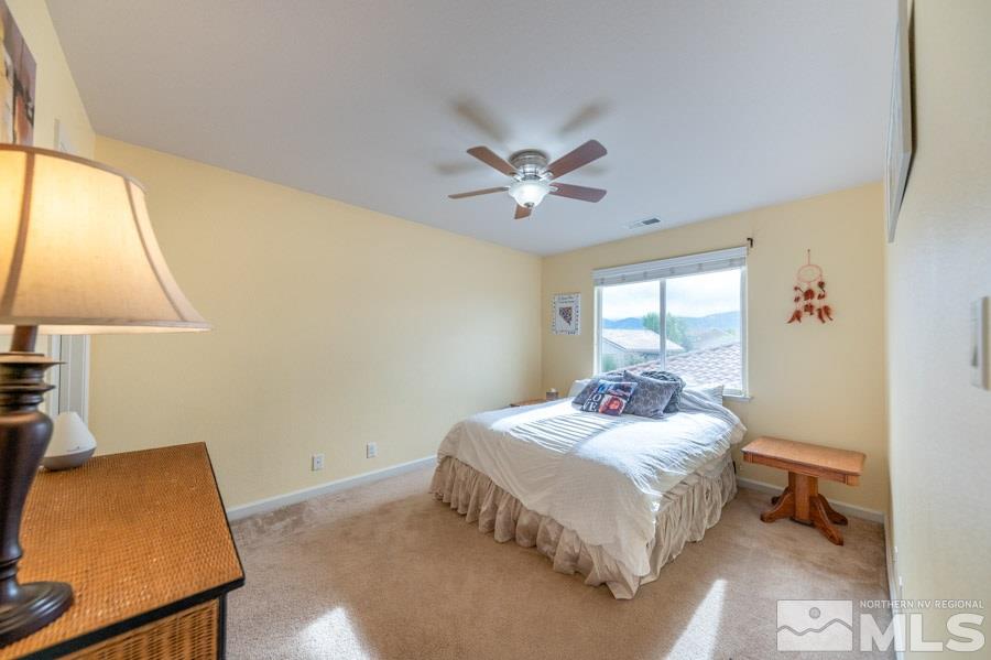 2104 Hazelcrest Drive Reno, NV 89521 - Photo 21 of 27 a bedroom with a bed and a lamp on dresser