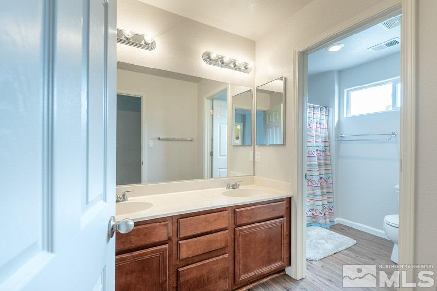 2104 Hazelcrest Drive Reno, NV 89521 - Photo 23 of 27 a bathroom with a sink and a mirror