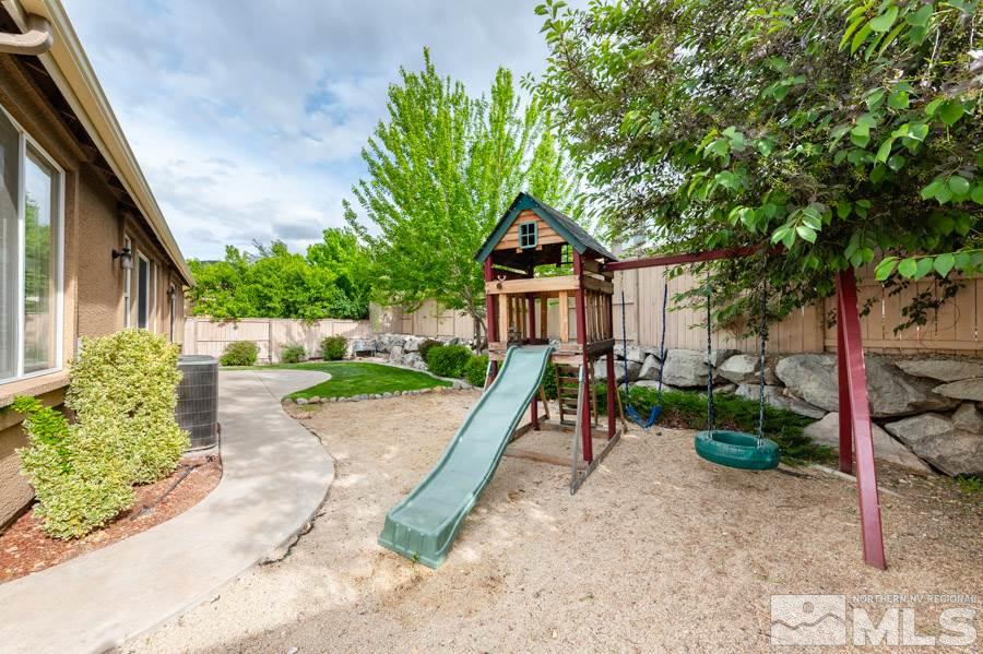 2104 Hazelcrest Drive Reno, NV 89521 - Photo 26 of 27 a view of a chair and tables in the backyard of the house
