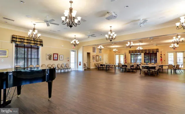 a view of a room with dining table and chairs