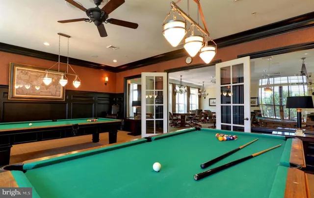 a room with pool table and windows