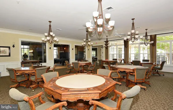 a view of a room with dining table and chairs