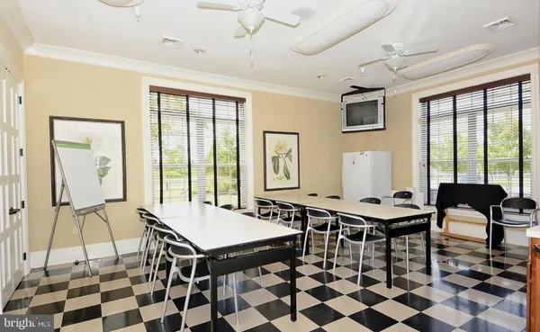 a view of a dining room with furniture a chandelier and wooden floor