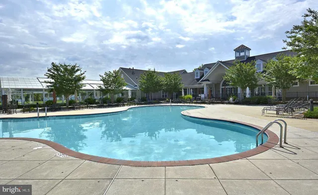 a view of a swimming pool with a yard