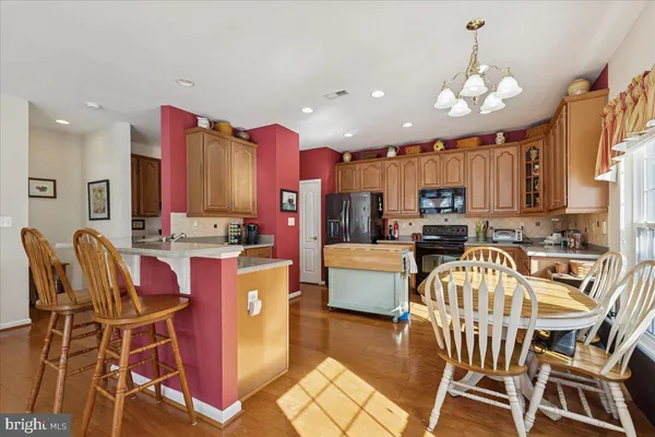 a living room with furniture a fireplace and a large window