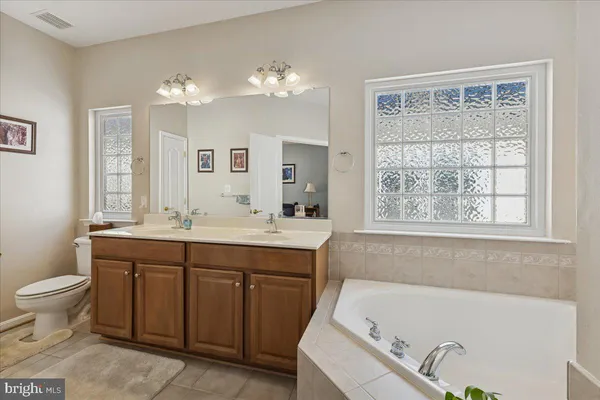 a bedroom with furniture and a large window