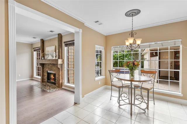 a dining room with furniture a chandelier and fireplace