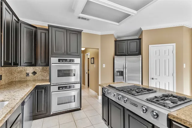 a kitchen with a stove and a refrigerator