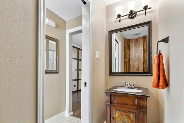 a bathroom with a sink a mirror and vanity