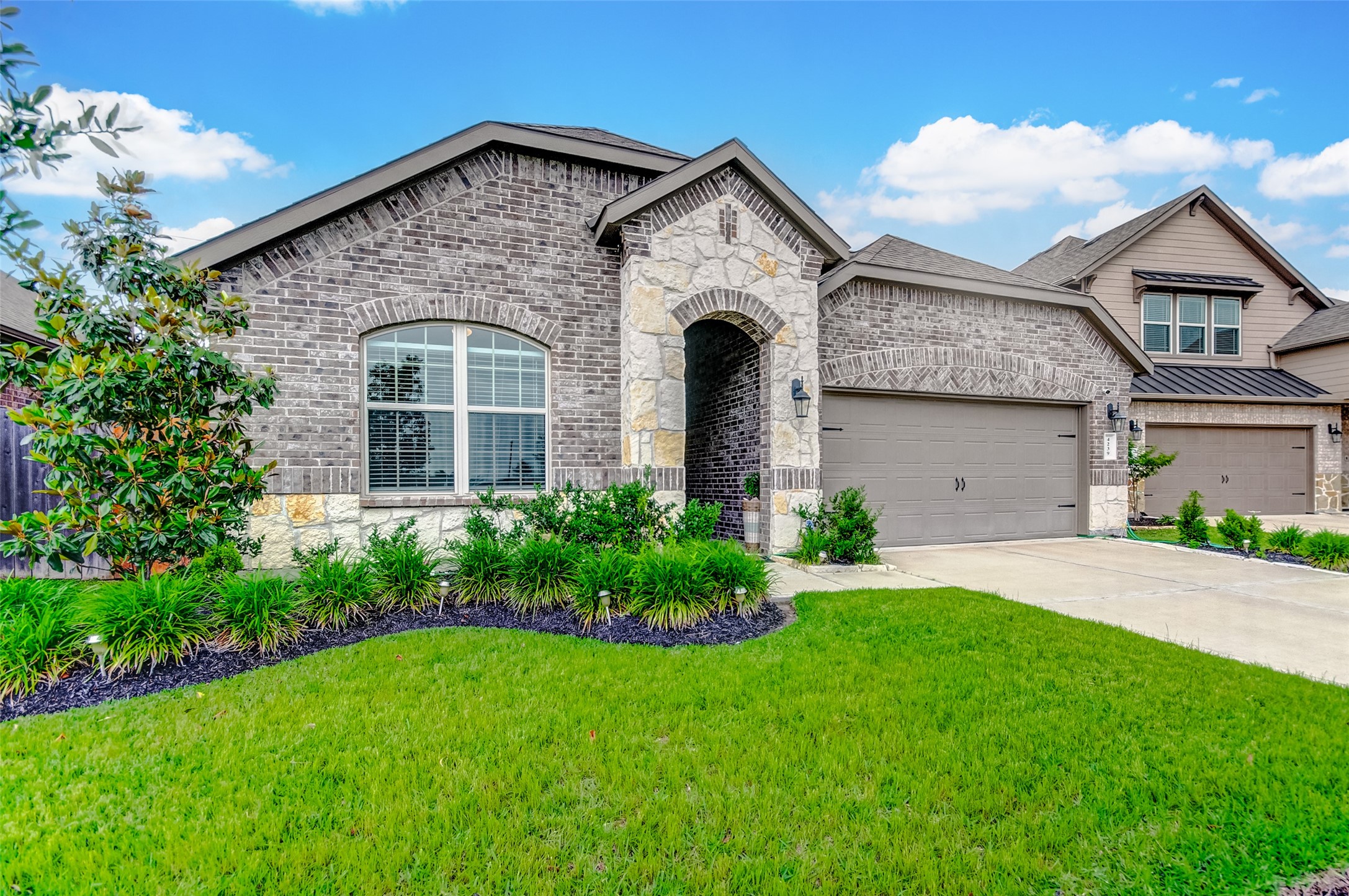 4239 Prairie Landing Lane Katy, TX 77494 - Photo 2 of 32 a front view of a house with a garden and plants
