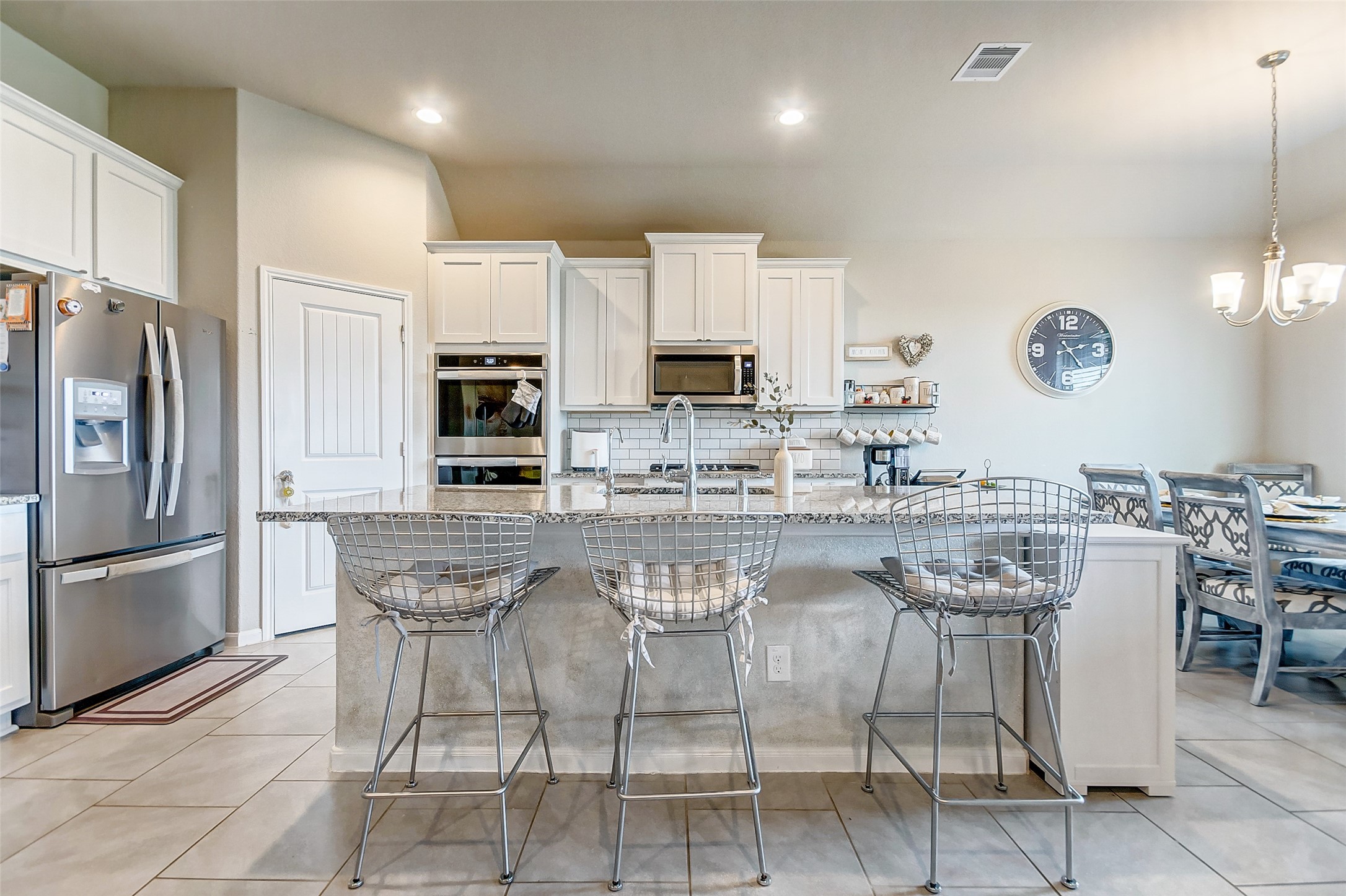 4239 Prairie Landing Lane Katy, TX 77494 - Photo 21 of 32 a kitchen with stainless steel appliances granite countertop a table and chairs