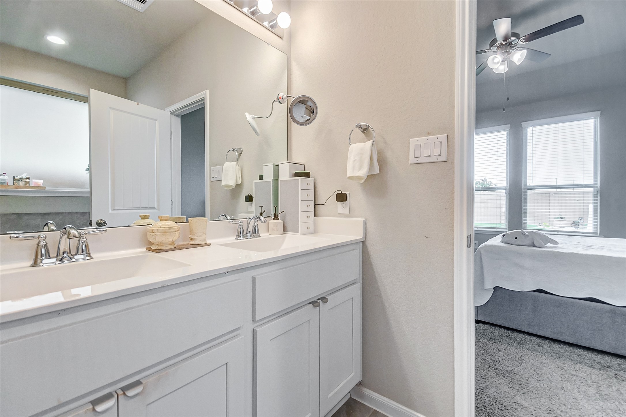 4239 Prairie Landing Lane Katy, TX 77494 - Photo 25 of 32 a en suite bathroom with a double vanity sink a mirror and a bathtub