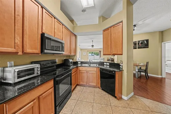 a bedroom with a bed a flat screen tv and a couch