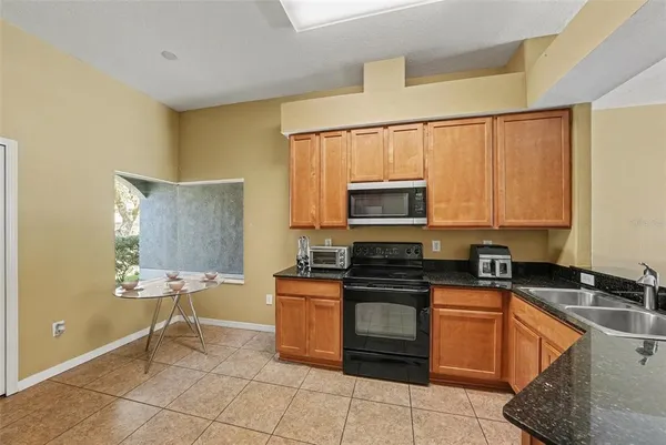 a bathroom with a tub double vanity sink and a mirror