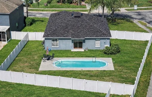 a front view of a house with a yard garage and outdoor seating
