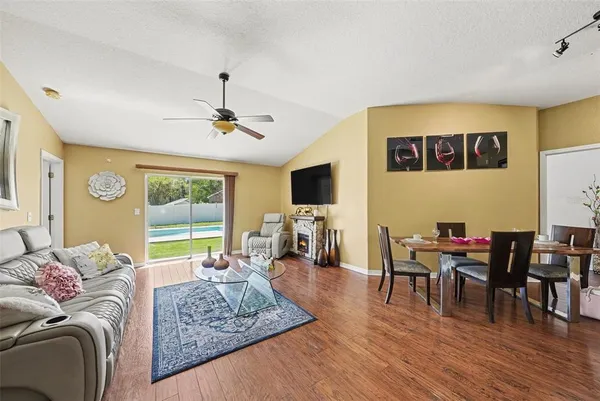a living room with furniture and wooden floor