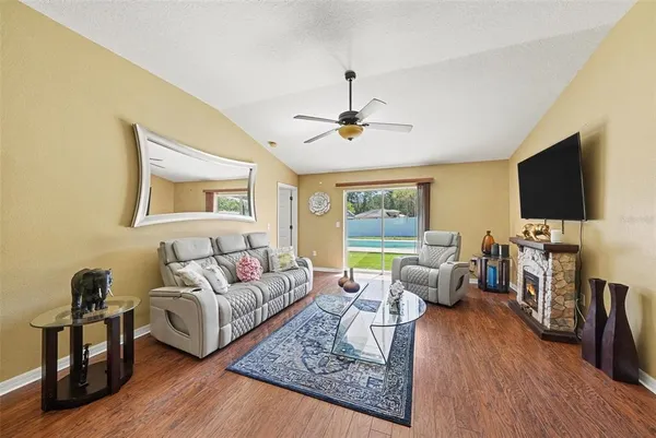 a living room with furniture a flat screen tv and a fireplace