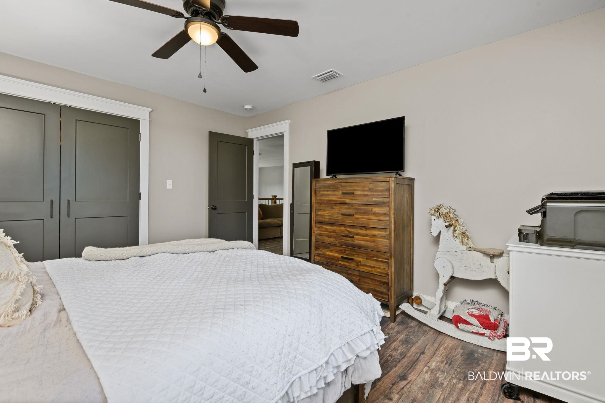 11025 Creax Road Axis, AL 36505 - Photo 32 of 45 Bedroom featuring wood-finish flooring, a ceiling fan with integrated lighting, and two panel closet doors